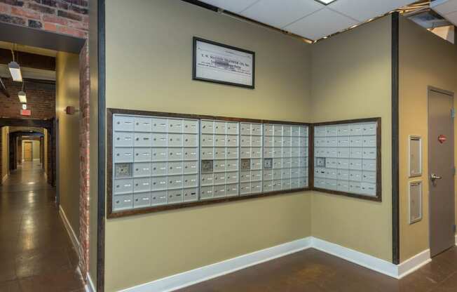 a wall with mailboxes on it in a hallway at Mayton Transfer Lofts, Petersburg Virginia