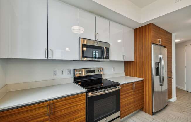 a kitchen with white countertops and wooden cabinets