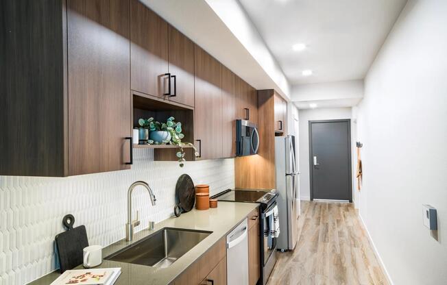 Modern cabinetry and sleek finishes make Modera Shoreline’s kitchens both stylish and functional—perfect for cooking or casual dining at home.