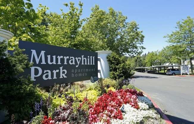 a sign park in front of a flower garden