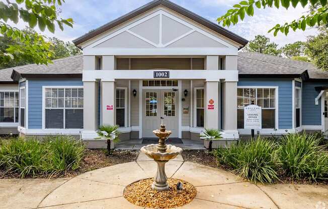 A blue building with a fountain in front of it.