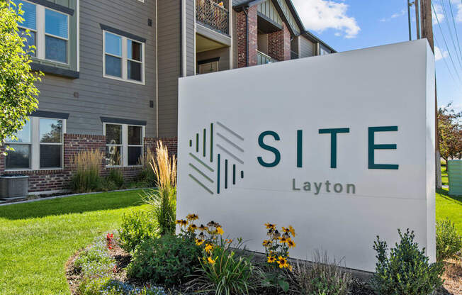 a sign that says site layton in front of a building