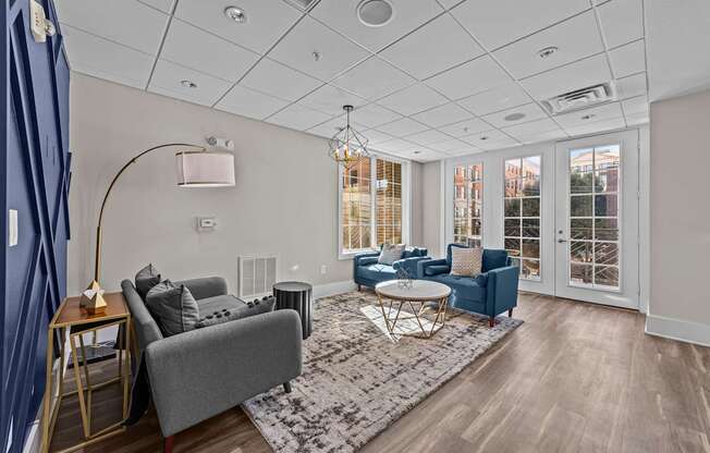 a living room with couches and chairs and a rug