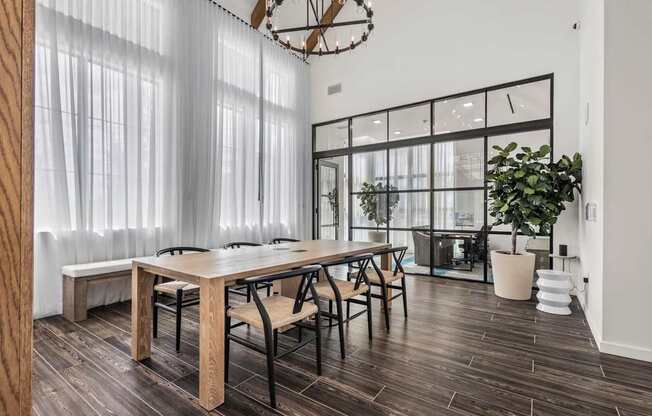 A dining room with a wooden table and chairs.