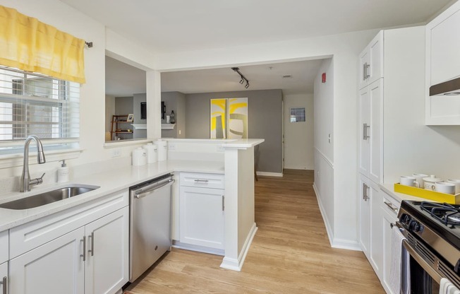 Orchards Apartments Marlborough ma apartment loft style apartments photo of kitchen stainless steel dishwasher and wood floors and white cabinets with dining room and living room with fireplace in background