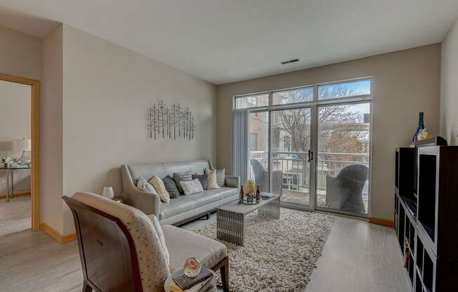 an aerial view of a living room with a staircase and a large window