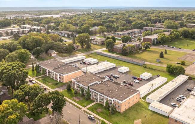 an aerial view of a campus with several buildings and a parking lot