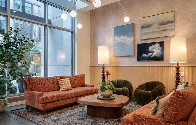 A living room with a brown couch, a green armchair, and a coffee table.