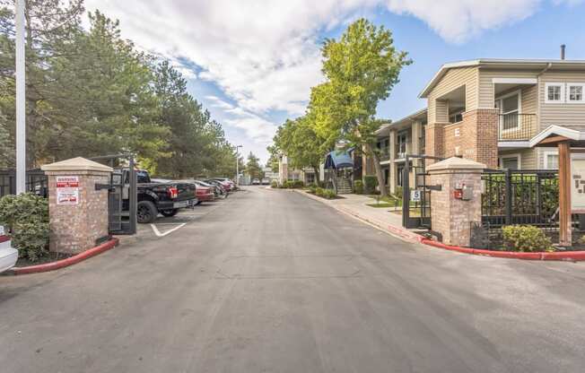 the enclave apartments exterior street view with cars parked on the side of the road