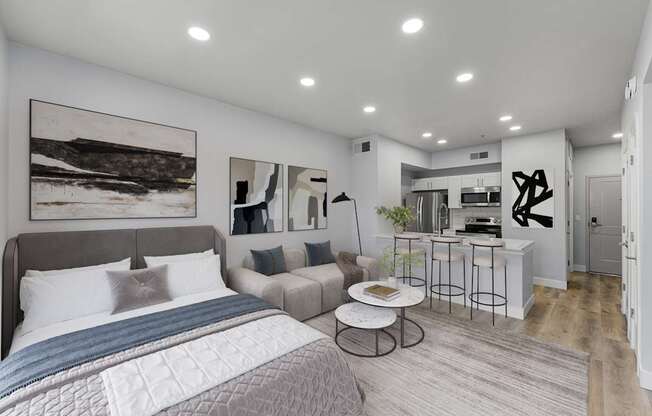 A bedroom with a large bed and a couch.