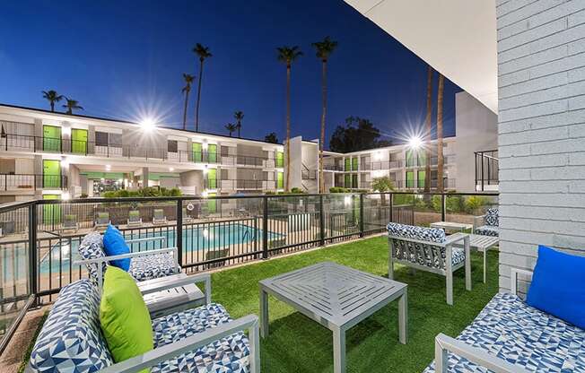 Outdoor Patio with Lounge Furniture and View of Pool at Arcadia on 49th Apartments located in Phoenix, AZ.