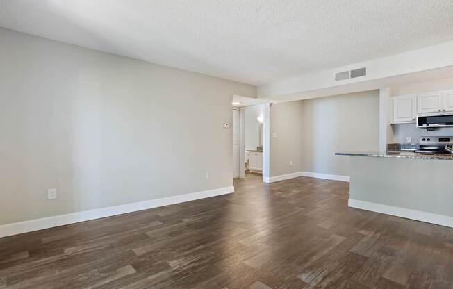Model living room with wood flooring at Seven Lakes at Carrollwood in Tampa, Florida.