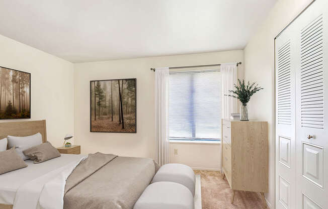 A bedroom with a bed, a nightstand, a cabinet, and a painting on the wall at West Wind Apartments, Fort Wayne, 46808