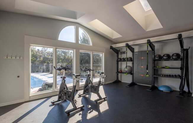 a gym with exercise equipment and a large window