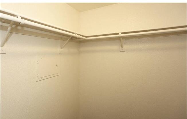 Closet with shelves at San Bellino Apartments, Glendale, AZ