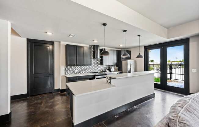 a kitchen with white countertops and black cabinets
