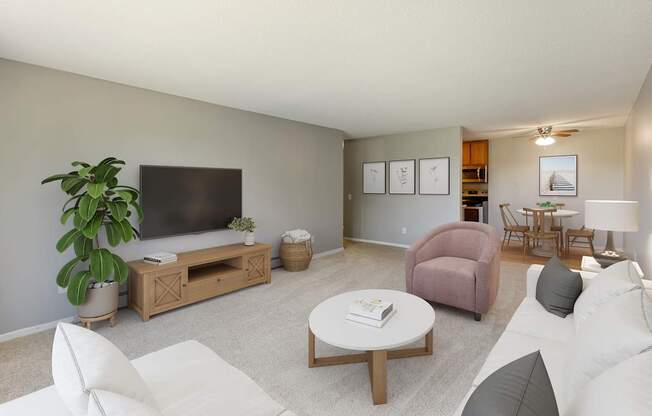 A living room with a white couch, a pink chair, a wooden coffee table, and a flat-screen TV.