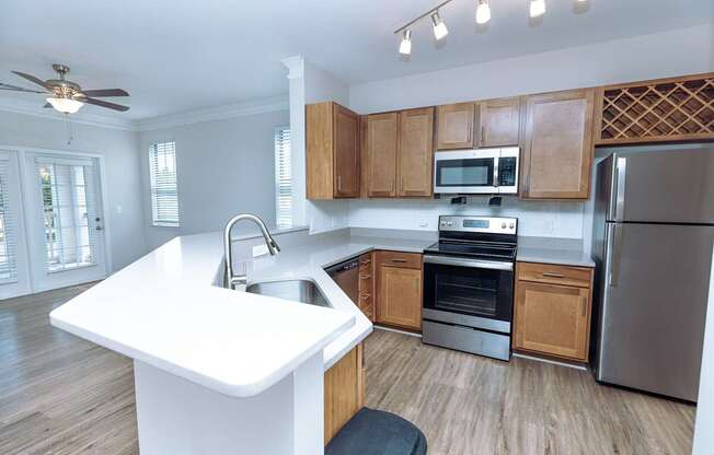 A kitchen with wooden cabinets and stainless steel appliances.