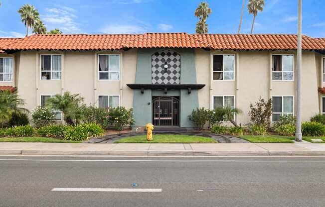 A building with a red tile roof and a black and white checkered awning.