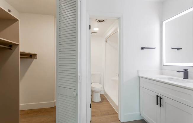 A white bathroom with a toilet and sink.