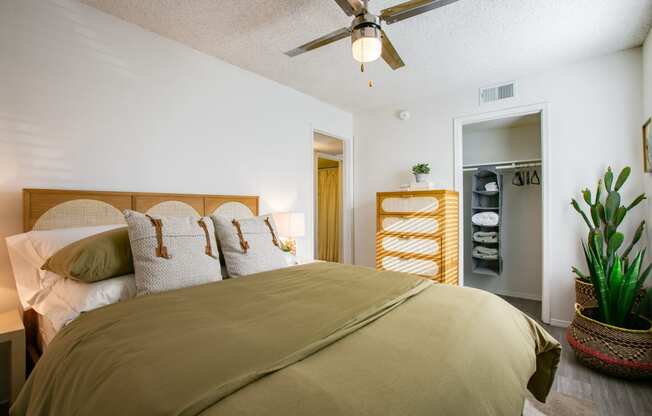 a bedroom with a bed and a ceiling fan