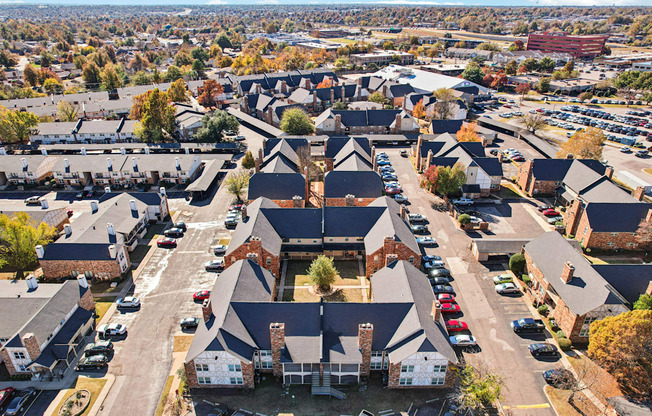 A bird's eye view of a residential area with houses and cars.