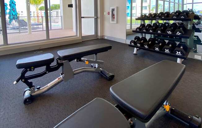 a gym with weights and a view of the beach at Icon One, Florida