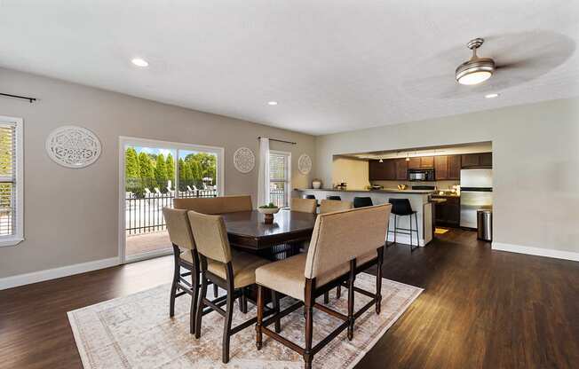 A dining room with a table and chairs.