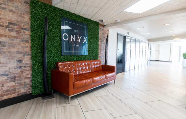 a living wall in an office lobby with a brown couch