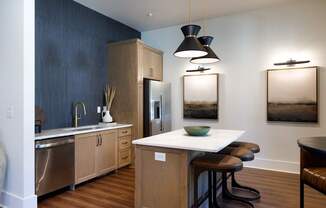 A kitchen with a white counter top and wooden cabinets.
