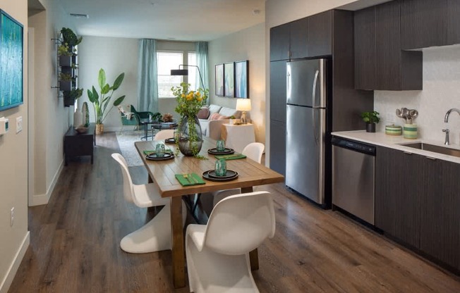 A modern kitchen with a dining table and chairs.