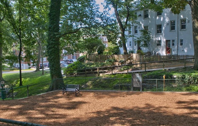 a park bench in front of a large house