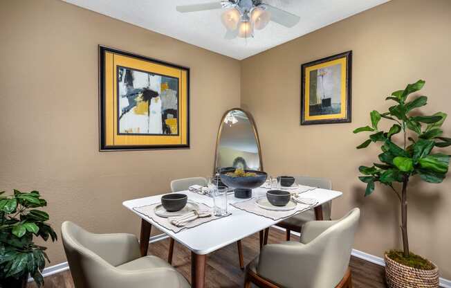 a dining room with a table and chairs and a ceiling fan