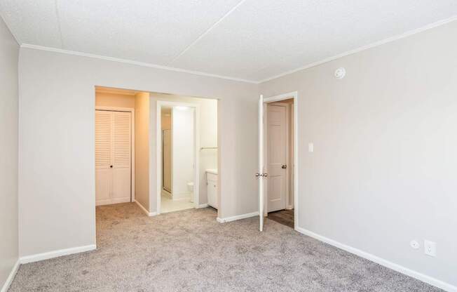 A room with a carpeted floor and white walls.