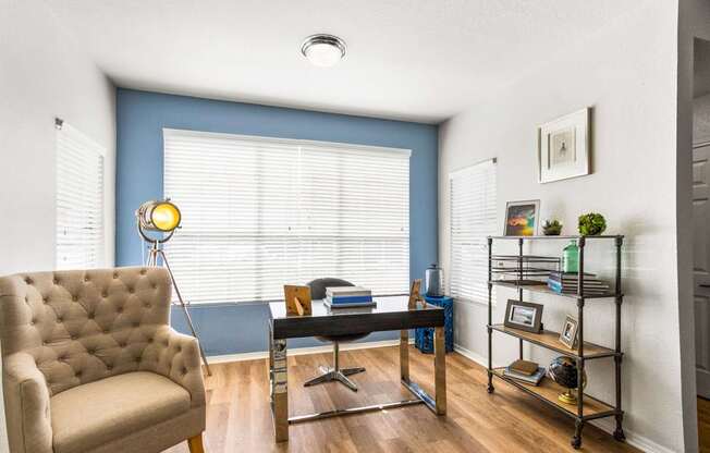 a living room with a large window and a couch and a table