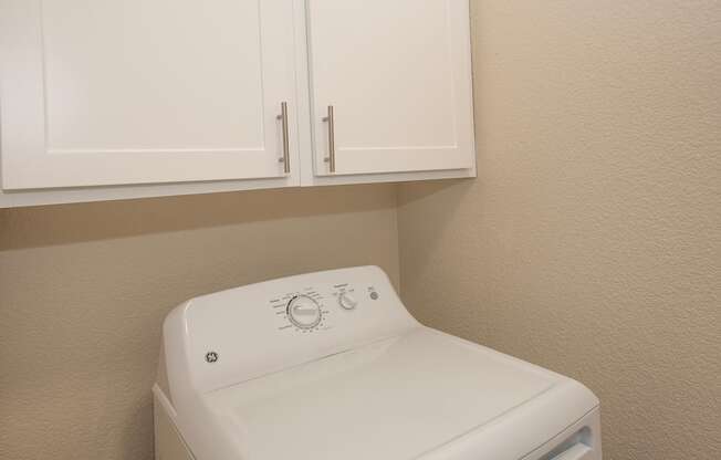 A white washing machine in a laundry room at Sunset Summit, Rocklin, CA, 95765