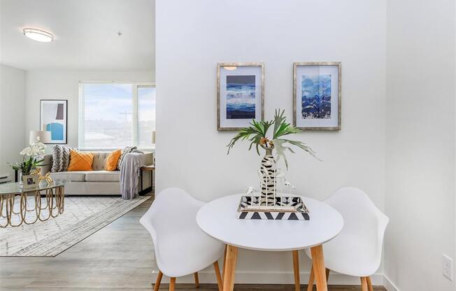 a dining area with a table and chairs and a couch in the background at Jefferson Yards, Tacoma, 98402