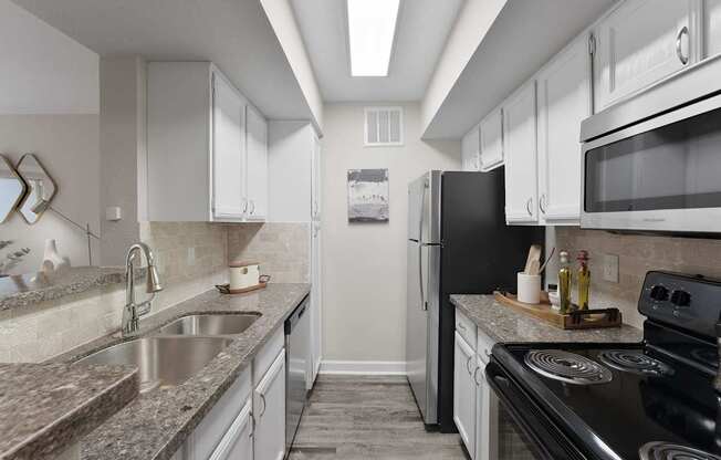 A kitchen with a black stove top oven.