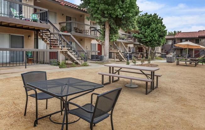 a group of lawn chairs sitting on top of a wooden table