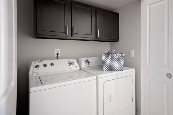 A white washing machine and dryer in a small laundry room.