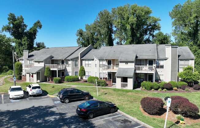 an apartment building with cars parked in front of it