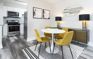 a dining room with yellow chairs and white tables at The Heights Apartments, Cincinnati, OH, 45220