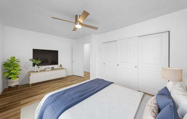 A bedroom with a large bed and a television.