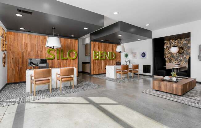 A modern office lobby with a wooden wall and a reception desk.