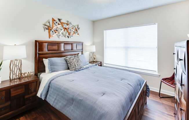 a bedroom with a large bed and a large window