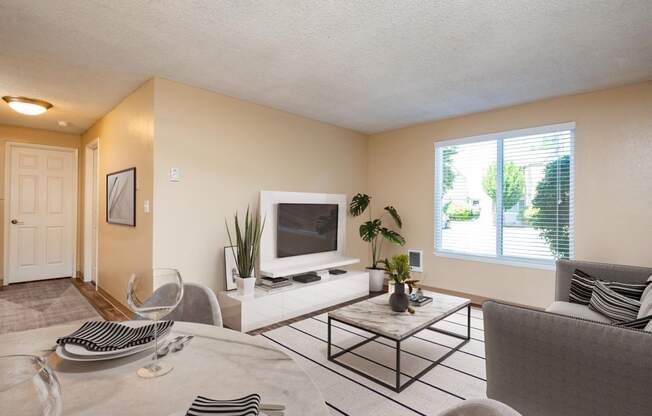 our apartments offer a living room and dining room with a tv