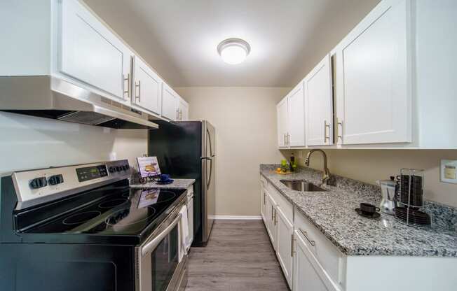 Updated white and grey kitchen with stainless steal appliances.