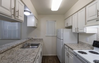 This is a photo of the kitchen in the 963 square foot 2 bedroom, 2 bath apartment at The Summit at Midtown Apartments in Dallas, TX.