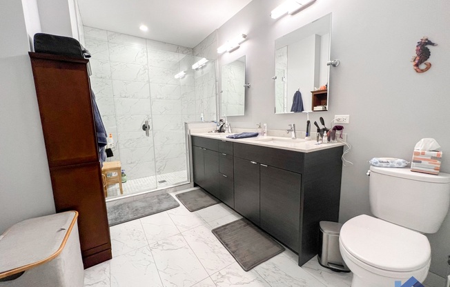 a bathroom with a toilet sink and shower