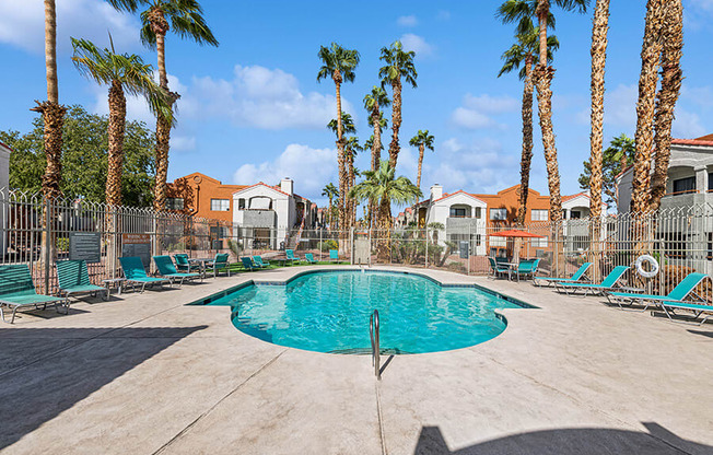 Community Swimming Pool with Pool Furniture at Stonegate Apartments located in Las Vegas, NV.